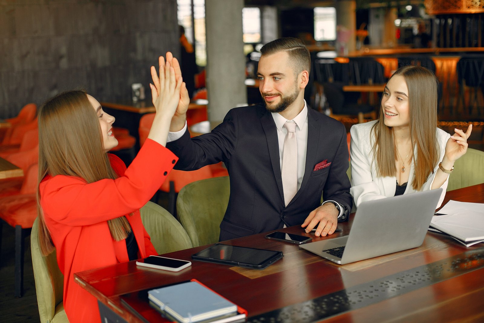 Partners sitting at the table and working in a cafe
